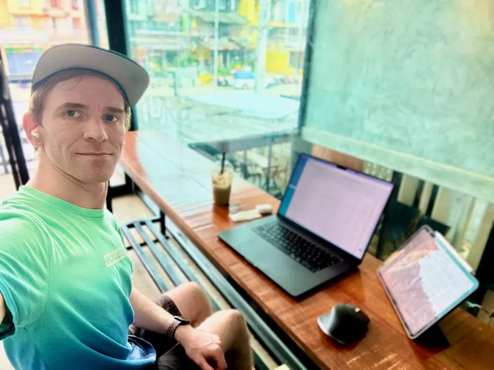 Christian arbeitet mit Laptop und Tablet in einem Café auf Ko Lanta (Thailand)